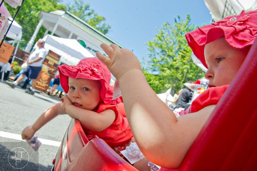 Ella Seals (right) and her twin sister Addie play with their newly bought hair bows during the May-retta Daze Arts & Craft Festival at Glover Park in Marietta on Sunday, May 4, 2014.