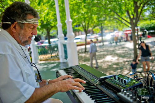 Bob Geresti plays the piano during the May-retta Daze Arts & Craft Festival at Glover Park in Marietta on Sunday, May 4, 2014.