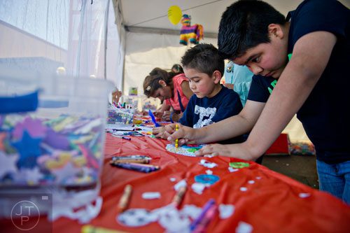 Dario Escobedo (right) and his brother Zuirel work on a craft project during the Cinco de Mayo Festival at Plaza Fiesta in Atlanta on Sunday, May 4, 2014. 