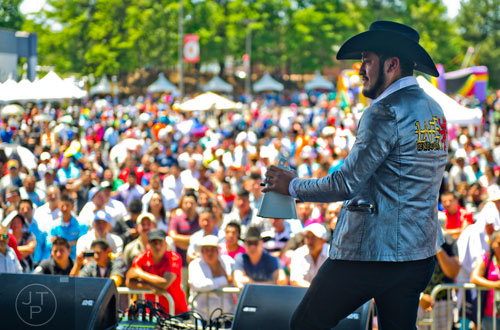 Jesse Gonzalez bangs on a cow bell as he performs on stage with La Fe de Nuevo Leon during the Cinco de Mayo Festival at Plaza Fiesta in Atlanta on Sunday, May 4, 2014. 