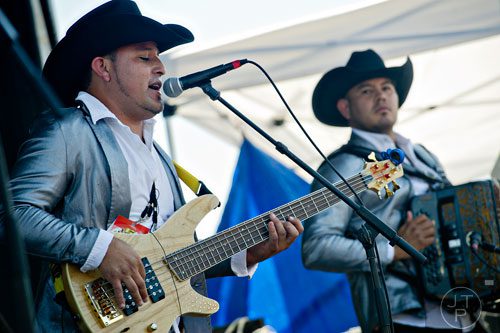Omar Mata and Daniel Munoz perform on stage with La Fe de Nuevo Leon during the Cinco de Mayo Festival at Plaza Fiesta in Atlanta on Sunday, May 4, 2014. 