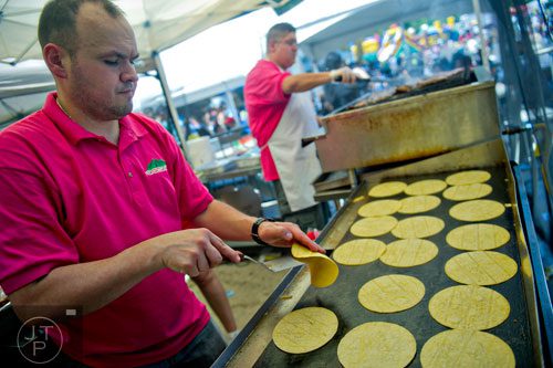 Tony Graza (left) and Pablo Licon grill ingredients for tacos during the Cinco de Mayo Festival at Plaza Fiesta in Atlanta on Sunday, May 4, 2014. 