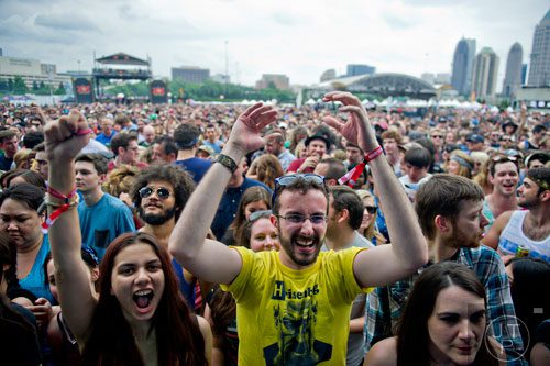Andrew DiPietro (center) and Leanne Sheth cheer as Dropkick Murphys perform on stage during the Shaky Knees Music Festival at Atlantic Station in Atlanta on Friday, May 9, 2014. 