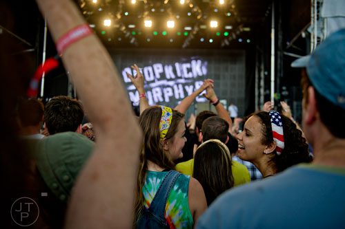 Lauren Goodman (right) smiles over at Dory DeWeese as Dropkick Murphys performs on stage during the Shaky Knees Music Festival at Atlantic Station in Atlanta on Friday, May 9, 2014. 