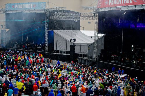 Thousands of people sit and stand as they listen to bands perform on two of the four stages set up during the Shaky Knees Music Festival at Atlantic Station in Atlanta on Friday, May 9, 2014. 