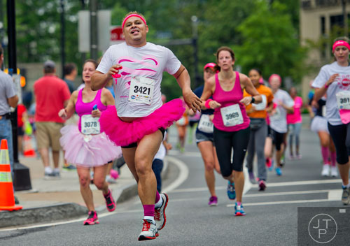 Hugo Navarro (3421) runs down Peachtree Rd. during the Susan G. Komen Race for the Cure in Atlanta on Saturday, May 10, 2014. 