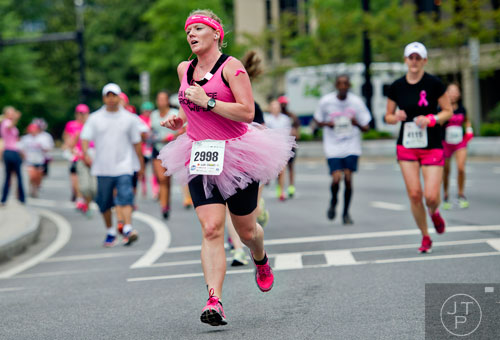Lori Heering runs down Peachtree Rd. during the Susan G. Komen Race for the Cure in Atlanta on Saturday, May 10, 2014.