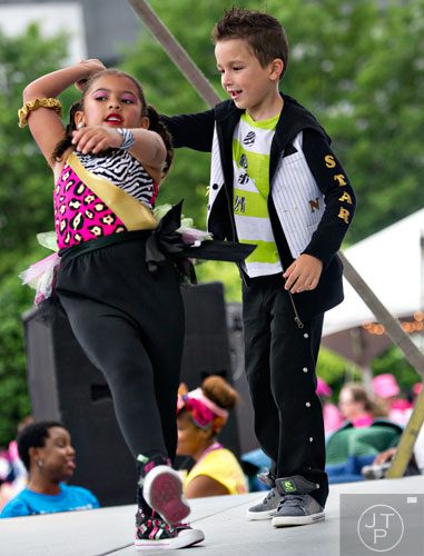 Nyla Burgess (left) dances on stage with Sebastian Marr after the Susan G. Komen Race for the Cure at Lenox Square Mall on Saturday, May 10, 2014. 