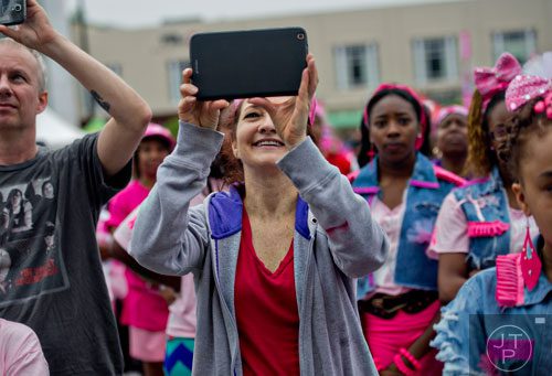 Karen Derr (center) records her daughter's performance after the Susan G. Komen Race for the Cure at Lenox Square Mall on Saturday, May 10, 2014. 