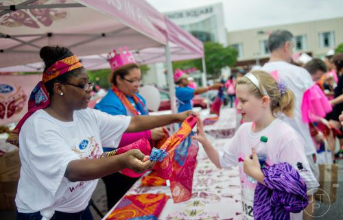 Christa Jackson (left) hands Rylee Chaney a scarf after the Susan G. Komen Race for the Cure at Lenox Square Mall on Saturday, May 10, 2014. 