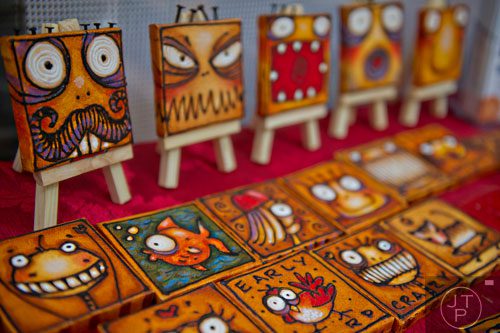 Artwork by Kevin Lahvic sits on display in his booth during the Buckhead Spring Arts & Crafts Festival at Chastain Park in Atlanta on Saturday, May 10, 2014.