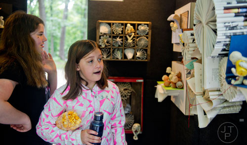 Reagan Little (left) and her sister Alex look at artwork by Daniel Lai during the Buckhead Spring Arts & Crafts Festival at Chastain Park in Atlanta on Saturday, May 10, 2014. 