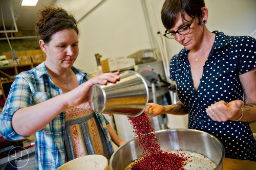 Suzi Sheffield (left) and Charlie Graham mix fresh ingredients with salt in a bowl at Beautiful Briny Sea in the Old Fourth Ward neighborhood of Atlanta on Wednesday, May 14, 2014. 