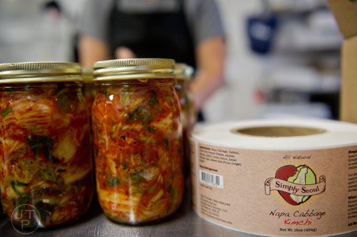 Labels sit next to jars of kimchi at the Simply Seoul Kitchen in Decatur on Thursday, May 15, 2014.   