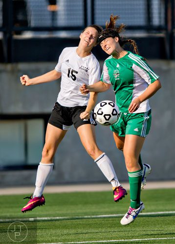 McIntosh's Jackie Gray (right) competes for the ball against Starr's Mill's Carly Pressgrove (15) during the Class AAAAA championship game at Kennesaw State University on Friday, May 16, 2014. 