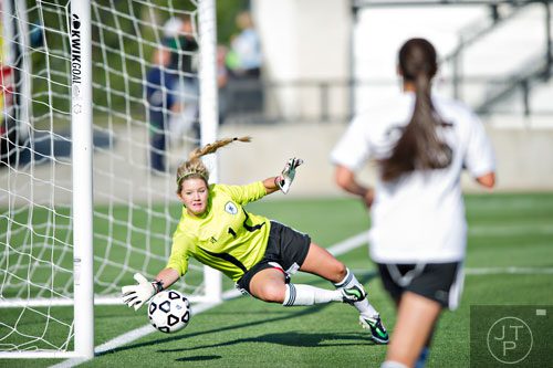 Starr's Mill's goalie Paige Betsill (1) dives towards the goalpost to block the ball from the net in their game against McIntosh during the Class AAAAA championship game at Kennesaw State University on Friday, May 16, 2014. 