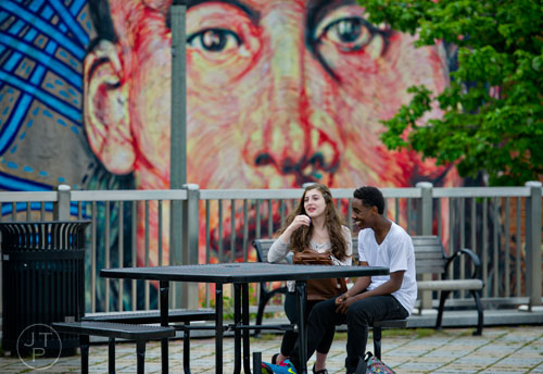 Juliette Torabi (left) and CJ Hines sit at one of the tables in the square in downtown Decatur on Wednesday, April 30, 2014. 