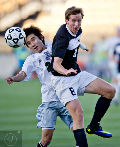 McIntosh's Daichi Uki (left) and Houston County's Will Pospisil (8) compete for control of the ball during the Class AAAAA championship game at Kennesaw State University on Friday, May 16, 2014.  