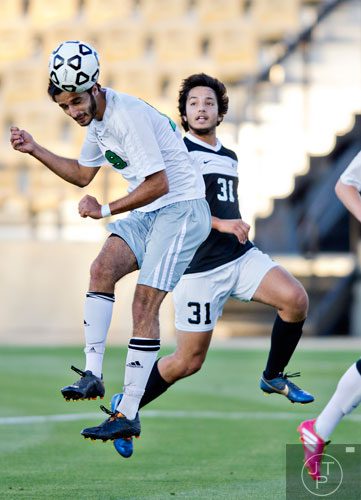 McIntosh's Adam Sheikali (19) heads the ball into the net for his second goal past Houston County's Brandon Aguilar (31) during the Class AAAAA championship game at Kennesaw State University on Friday, May 16, 2014. 