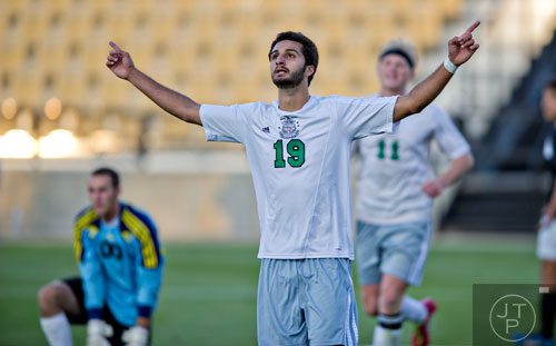 McIntosh's Adam Sheikali (19) celebrates after scoring his second goal of their game against Houston County during the Class AAAAA championship game at Kennesaw State University on Friday, May 16, 2014.   