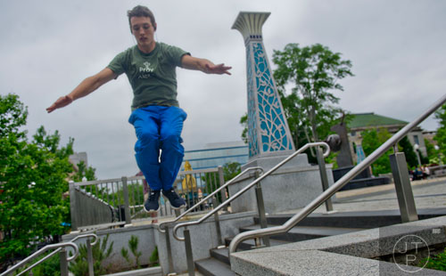 Dylan Moore leaps from a railing as he practices parkour, a form of martial arts, in downtown Decatur on Wednesday, April 30, 2014. 