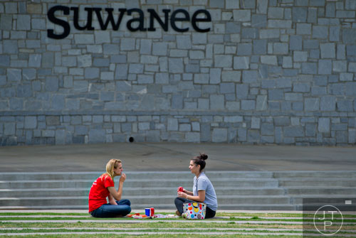 Mariah Jewell (left) talks with Nicole Tvrdik as they eat lunch on the green in downtown Suwanee on Thursday, May 1, 2014.  