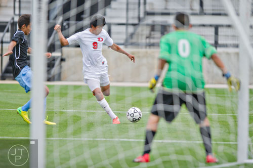 Dalton's Isai Hernandez (9) takes a shot on goal in their game aganst Johnson during the Class AAAA championship soccer game at Kennesaw State University on Saturday, May 17, 2014. 