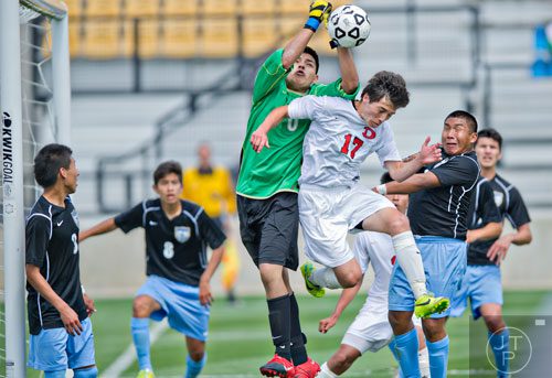 Dalton's Kobe Perez (17) tries to head the ball past Johnson goalie Ivan Salcido (0) as he knocks the ball away during the Class AAAA championship soccer game at Kennesaw State University on Saturday, May 17, 2014. 