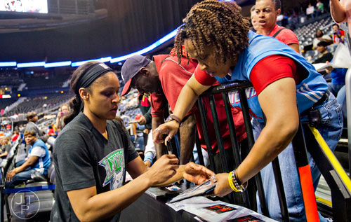 Minnesota Lynx forward Maya Moore (left) signs an autograph for LaFave Dean before taking on the Atlanta Dream at Philips Arena on Friday, June 13, 2014.   