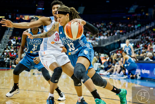 Minnesota's Seimone Augustus (35) drives past Atlanta's Angel McCoughtry (35)  during their game at Philips Arena in Atlanta on Friday, June 13, 2014.   
