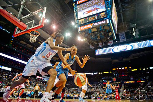 Atlanta's Tiffany Hayes (15) and Minnesota's Damiris Dantas (right) chase after a loose ball during their game at Philips Arena in Atlanta on Friday, June 13, 2014. 