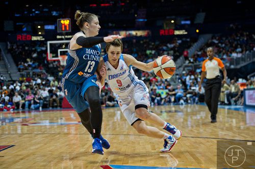 Atlanta's Celine Dumerc (9) drives past Minnesota's Lindsay Whalen (13) during their game at Philips Arena in Atlanta on Friday, June 13, 2014. 