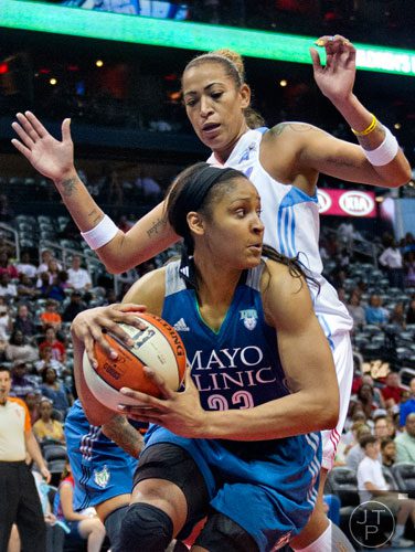 Minnesota's Maya Moore (23) is guarded by Atlanta's Erika de Souza  during their game at Philips Arena in Atlanta on Friday, June 13, 2014. 