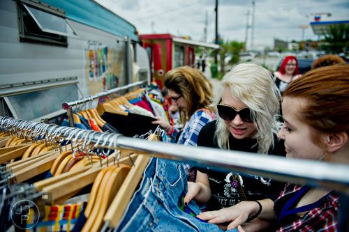 Lauren Dunlop (right), Alex Sulkoske and Rachael Sizemore look at clothing for sale during the Indie Craft Experience at Ambient Plus Studio in Atlanta on Saturday, June 28, 2014. 