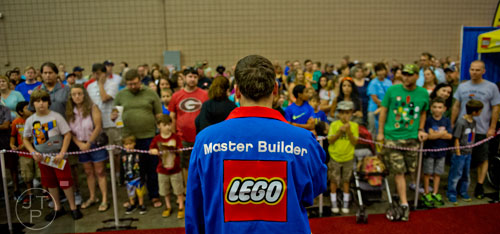 Master Builder Chris Steininger (center) gets the crowd pumped before they are let loose into the LEGO KidsFest at the Cobb Galleria Centre in Atlanta on Saturday, June 28, 2014. 