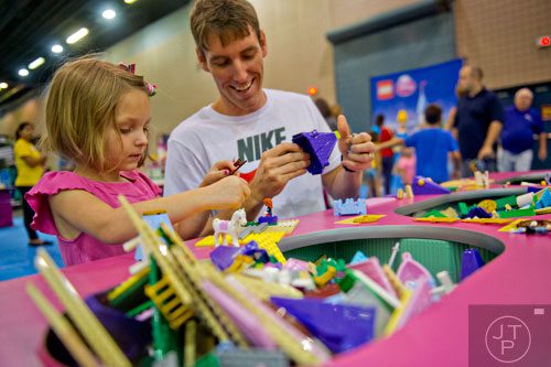 Reese Weber (left) and her father Rudy build a princess scene during the LEGO KidsFest at the Cobb Galleria Centre in Atlanta on Saturday, June 28, 2014. 