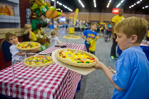 Charlie Billington (right) and his brother Sam race wih pizzas made of LEGOs during the LEGO KidsFest at the Cobb Galleria Centre in Atlanta on Saturday, June 28, 2014. 