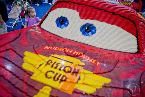 Sarah Edge (left) looks at a Lightning McQueen from the movie Cars made completely of LEGOs during the LEGO KidsFest at the Cobb Galleria Centre in Atlanta on Saturday, June 28, 2014. 