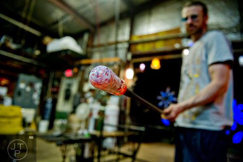 Nate Nardi works on creating a bowl as he blows glass at his studio in Decatur on Friday, May 23, 2014. 
