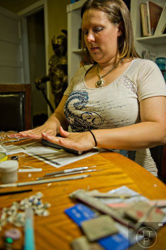 Megan Austin uses precious metal clay to create pieces of hand crafted jewelry at her home in Canton on Tuesday, May 27, 2014.  