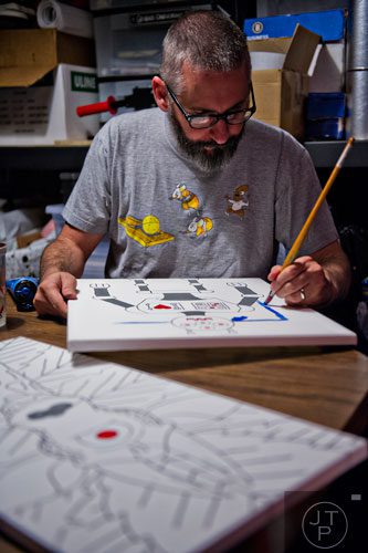Jay Hornsby uses paint to create a signature pop art piece at his home in East Atlanta Village on Thursday, May 29, 2014.  