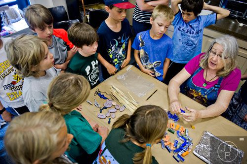 Pam Beagle-Daresta (right) demonstrates how to mix clay to her campers during the Son of Sobek week at Camp Carlos at the Michael C. Carlos Museum on the Emory University campus in Atlanta on Tuesday, June 3, 2014.   