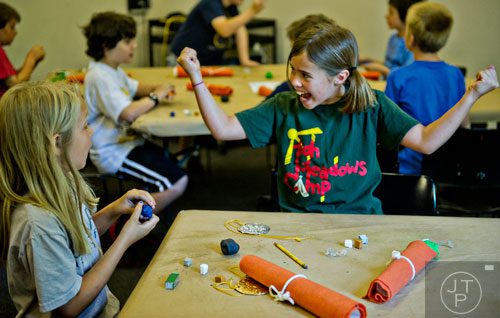 Claudia Restler (right) and Georgie Weaver make Egyptian themed amulets during the Son of Sobek week at Camp Carlos at the Michael C. Carlos Museum on the Emory University campus in Atlanta on Tuesday, June 3, 2014. 