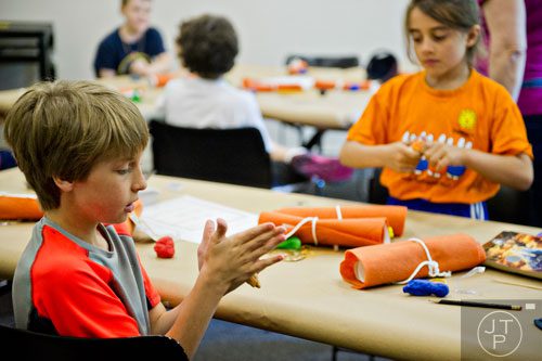 Owen Moriarty (left) and Aarini Ransom make an Egyptian themed amulets during the Son of Sobek week at Camp Carlos at the Michael C. Carlos Museum on the Emory University campus in Atlanta on Tuesday, June 3, 2014.