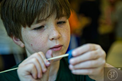 Mac Wickland makes an Egyptian themed amulet during the Son of Sobek week at Camp Carlos at the Michael C. Carlos Museum on the Emory University campus in Atlanta on Tuesday, June 3, 2014. 