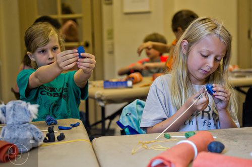 Georgie Weaver (right) and Ella Kemmerly make Egyptian themed amulets during the Son of Sobek week at Camp Carlos at the Michael C. Carlos Museum on the Emory University campus in Atlanta on Tuesday, June 3, 2014. 