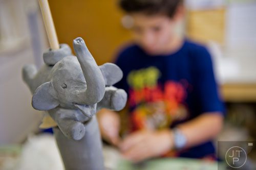A clay elephant sits on a sculpture during Summer Youth Art Weeks at the Abernathy Arts Center in Sandy Springs on Wednesday, June 4, 2014.  