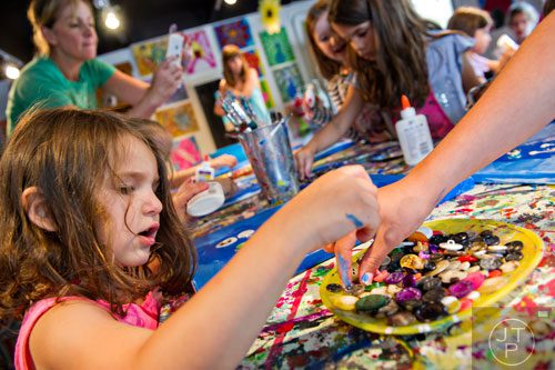 Mitzi Thaler (left) reaches for buttons as she makes a multimedia seahorse during Beach Week at the Farmhouse in the City in Roswell on Wednesday, June 4, 2014. 