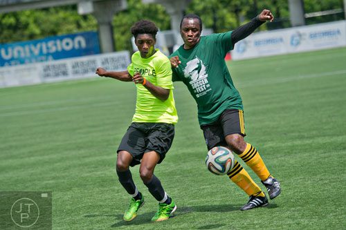 Tyrik Francis (left) and Peter Ngcobo collide as they compete for control of the ball during the Atlanta International Soccer Fest at the Atlanta Silverbacks' soccer complex on Saturday, June 7, 2014. 