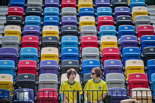 Jonathan DeMatos (left) sits in the stands with his mother Elaine as they watch soccer during the Atlanta International Soccer Fest at the Atlanta Silverbacks' soccer complex on Saturday, June 7, 2014. 